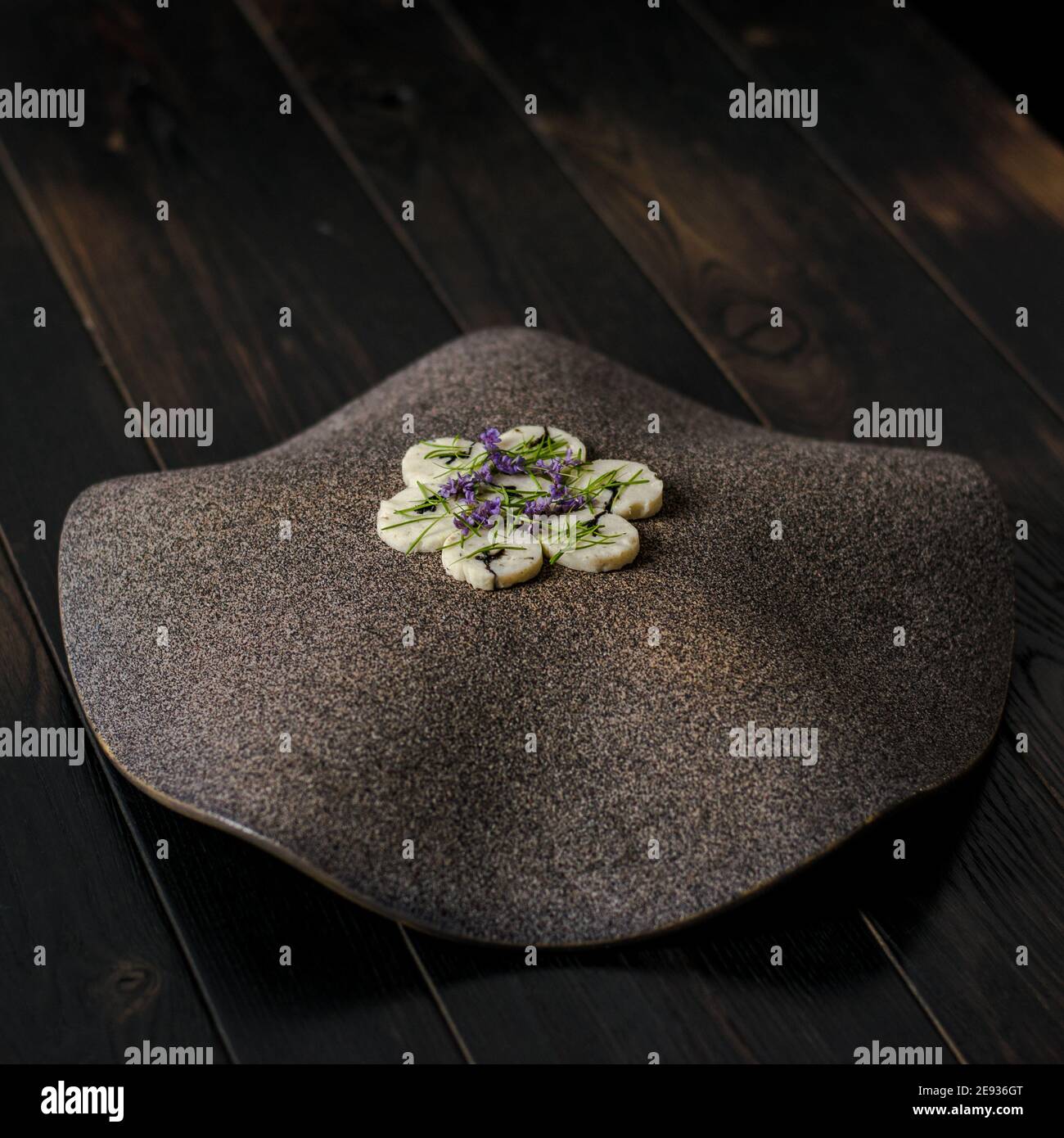 Fish roulade on an interesting plate decorated with fir needles at a ...