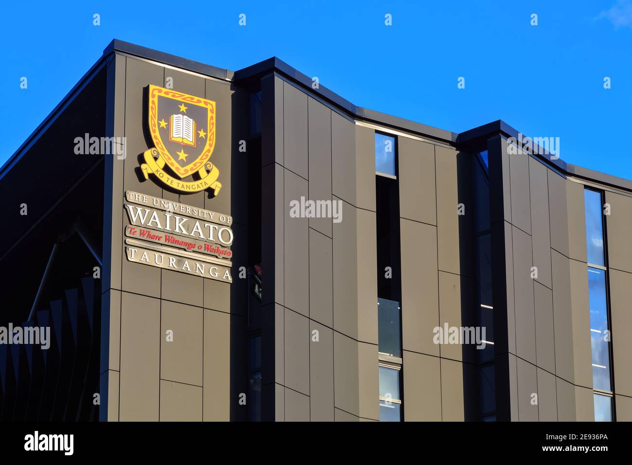 The logo of the University of Waikato on their campus building in Tauranga, New Zealand Stock Photo