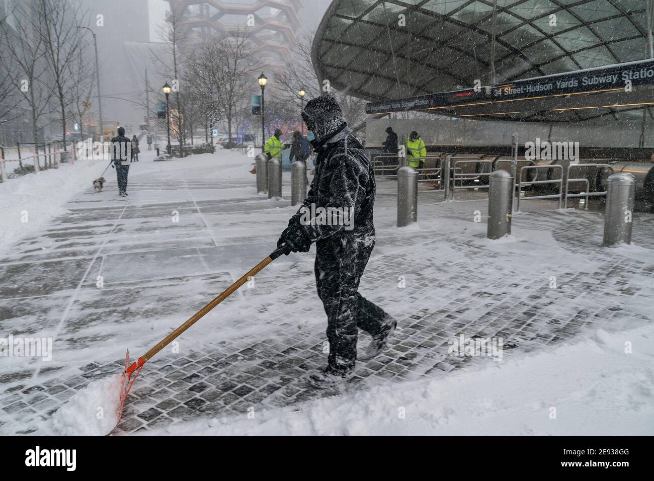 New York, United States. 01st Feb, 2021. Maintenance workers clear snow at Hudson Yards subway station entrance as major storm cover New York City with more than a foot expected on the ground. This snow storm called nor'easter storm. Heavy snowfall expected to continue for more than 24 hours. Snow storm impacted all North East of the US. (Photo by Lev Radin/Pacific Press) Credit: Pacific Press Media Production Corp./Alamy Live News Stock Photo