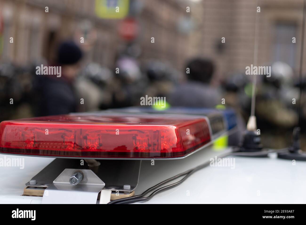 Police alarm siren on car close-up with blurry background with riot police Stock Photo