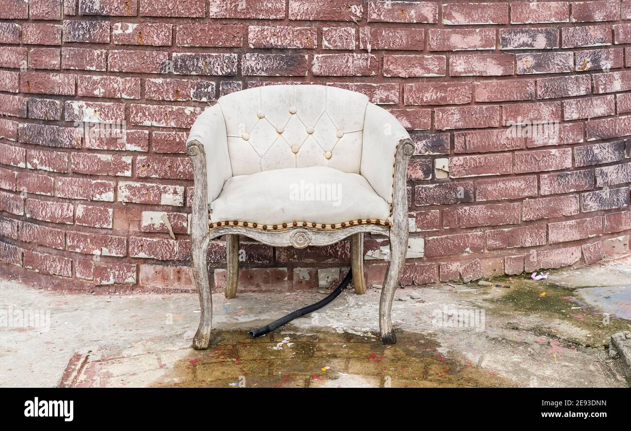old abandoned house front with blue sofa Stock Photo
