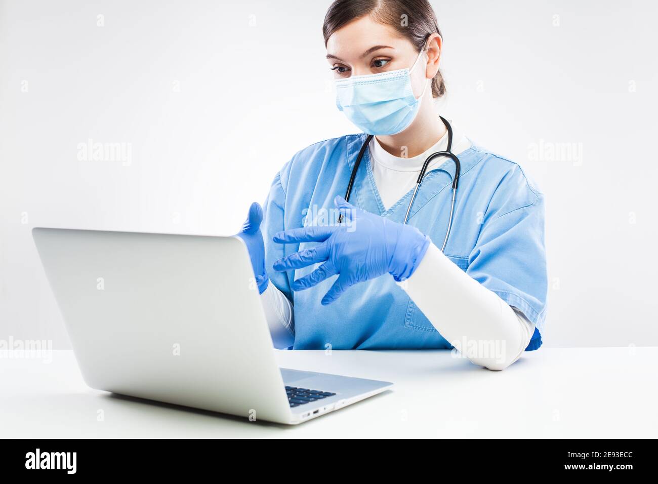 UK NHS GP doctor chatting to patient over computer,general practitioner in office zoom video call during Coronavirus lockdown,televisit healthcare con Stock Photo