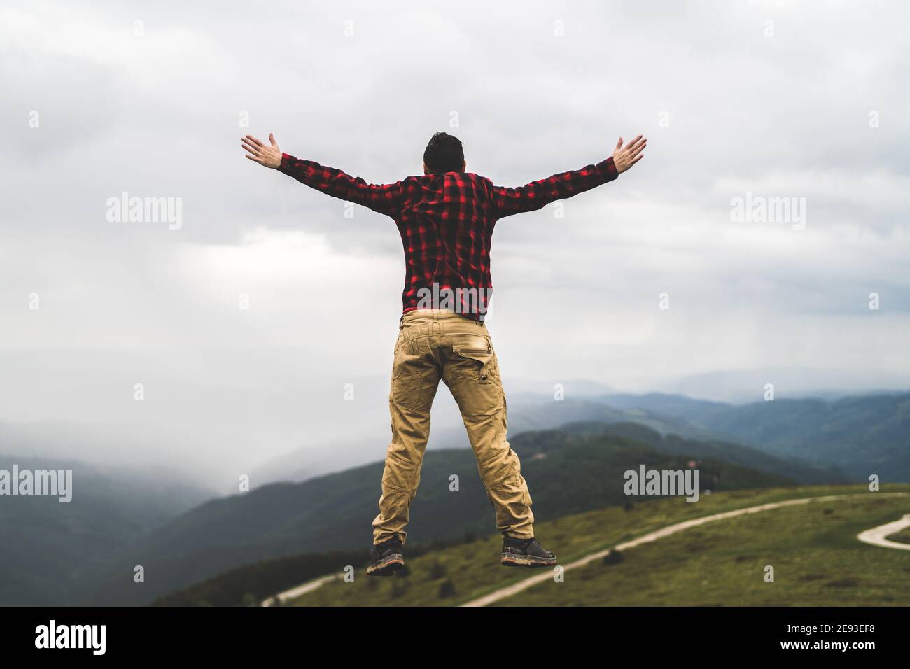 Carefree jump in mountain peak Stock Photo