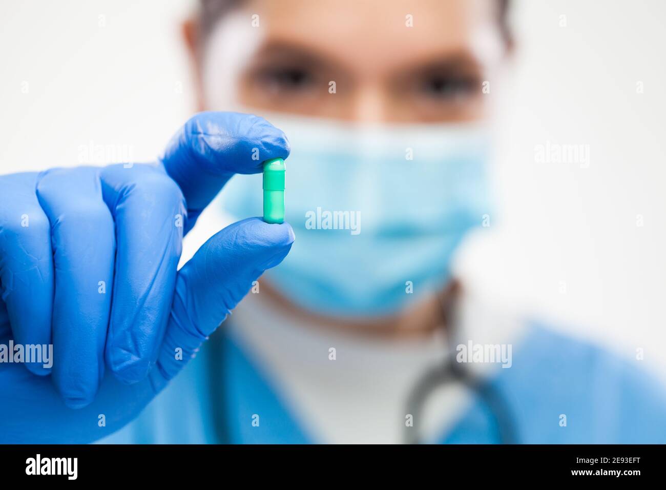 Female UK NHS GP general practitioner doctor wearing protective face