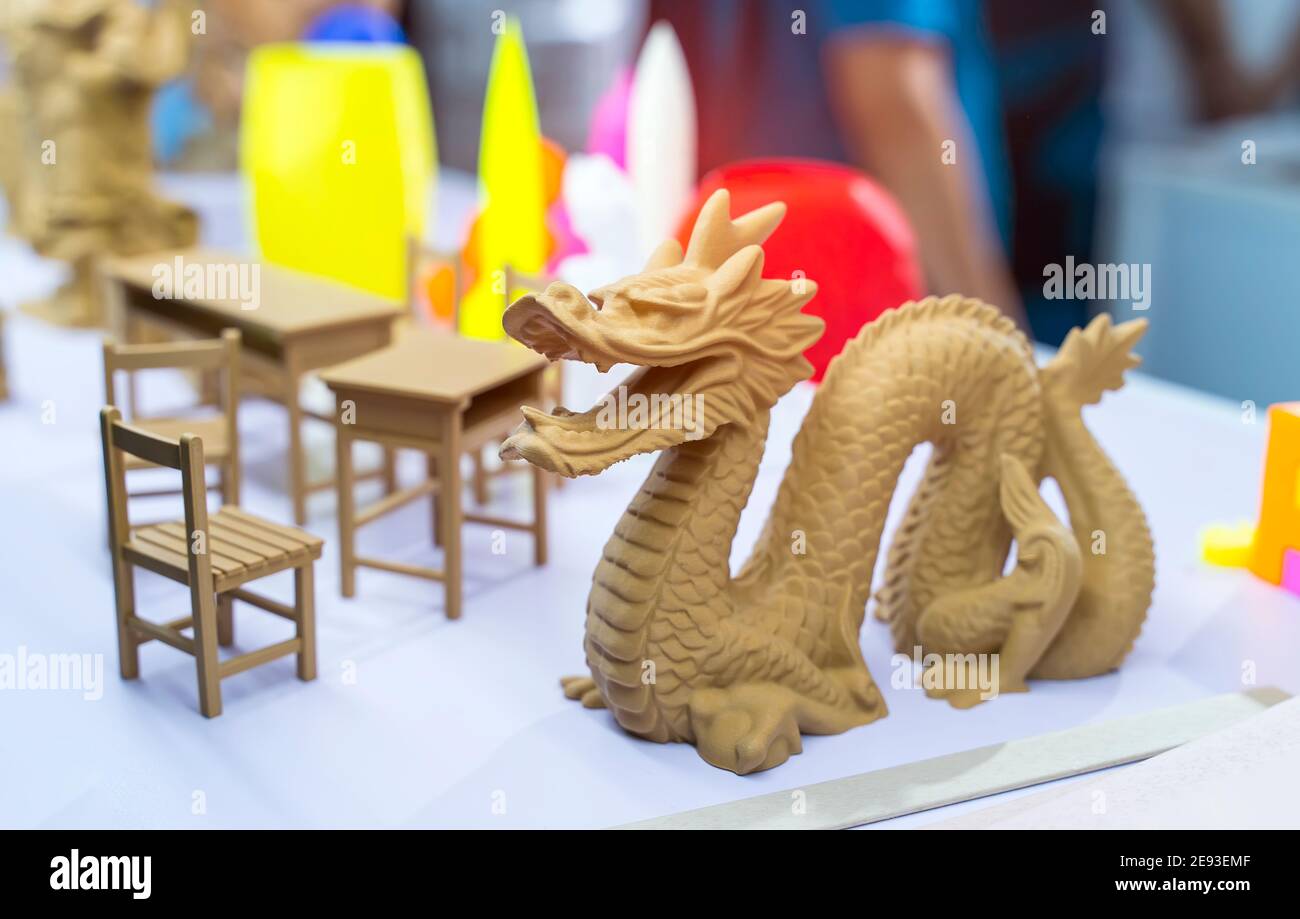 3D printer printing dragon head figure close-up. Stock Photo