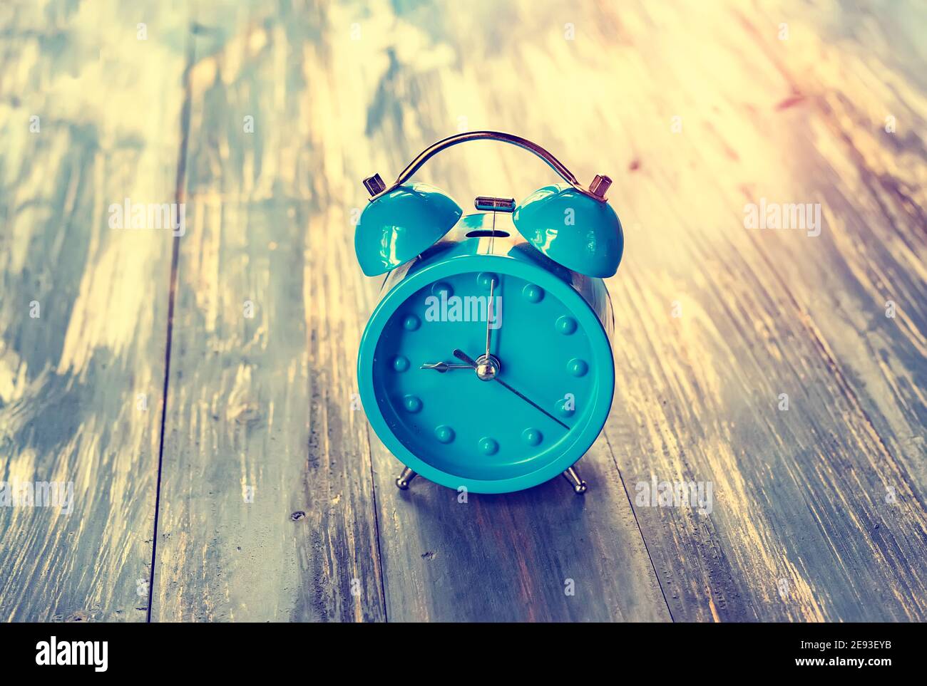 blue clock on antique rustic wood background Stock Photo - Alamy