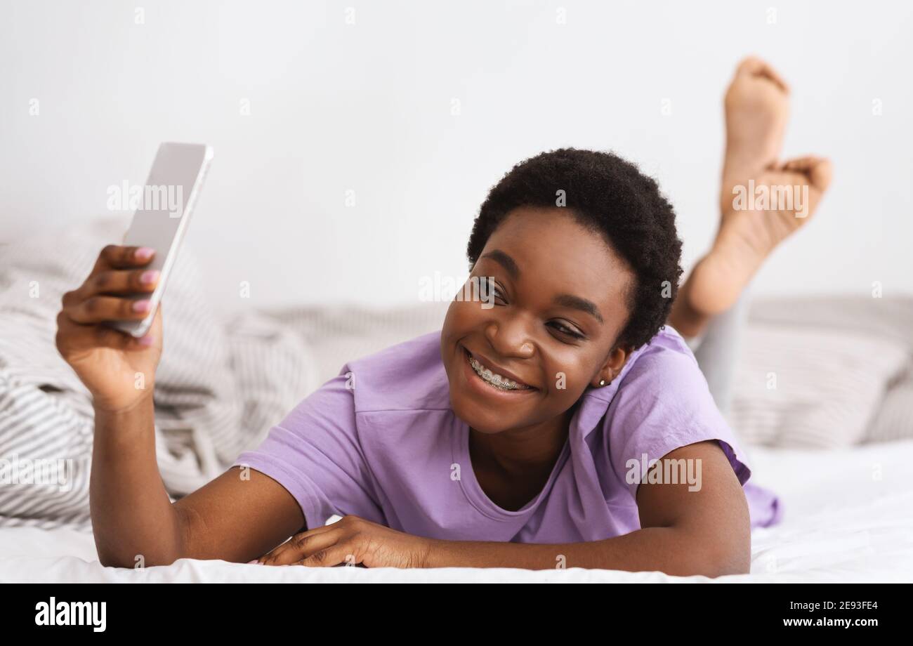 Selfies in bed for social networks and great mood in morning at weekend Stock Photo