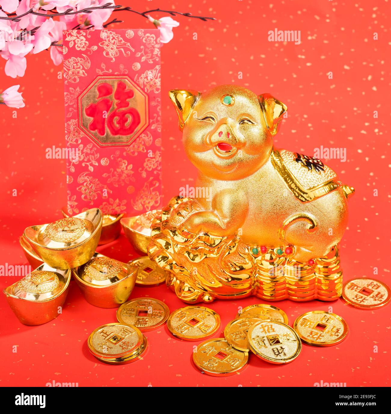 Golden piggy bank with red background,calligraphy translation: good bless for saving and wealth. Chinese Language on envelop mean Happiness and on ing Stock Photo