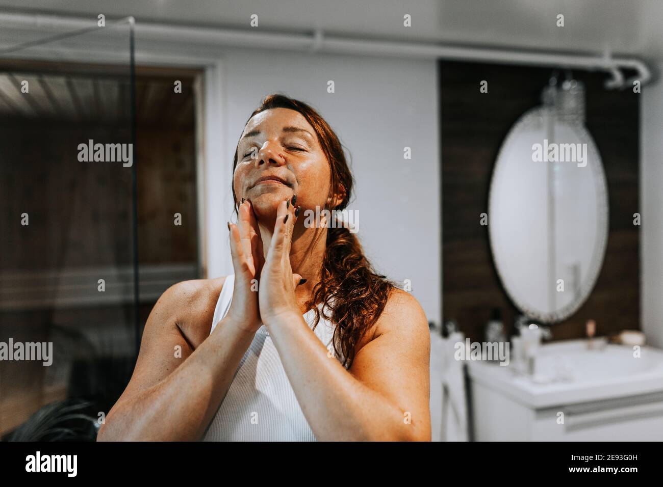 Woman massaging her face Stock Photo