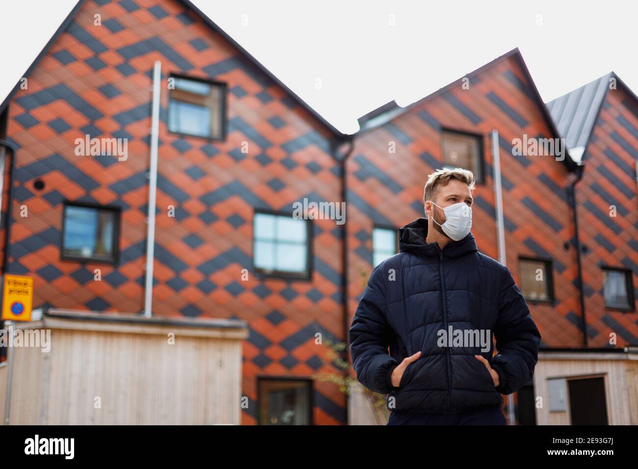 Man wearing face mask looking away Stock Photo