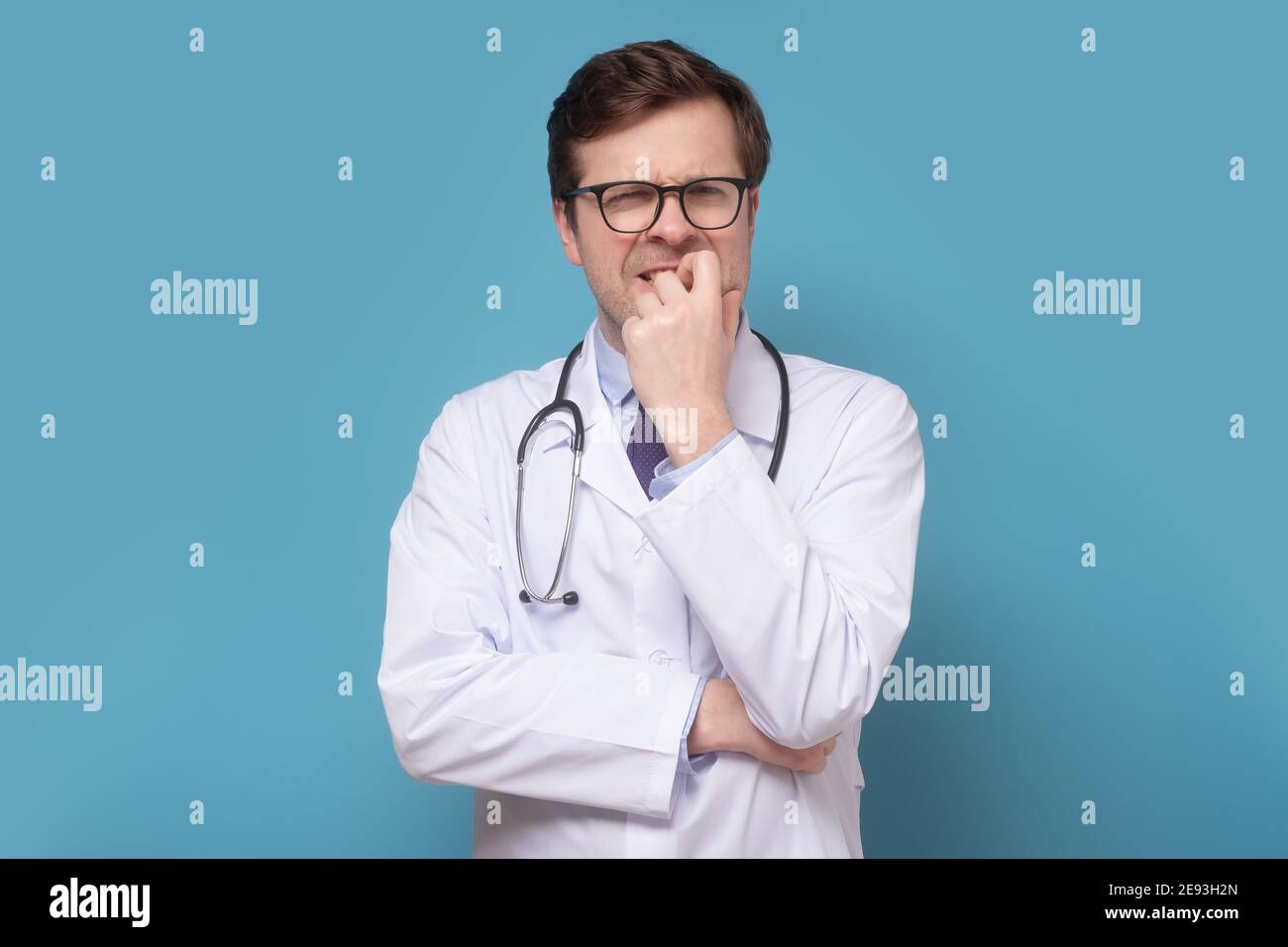 Insecure male doctor biting his nails looking funny scared craving ...