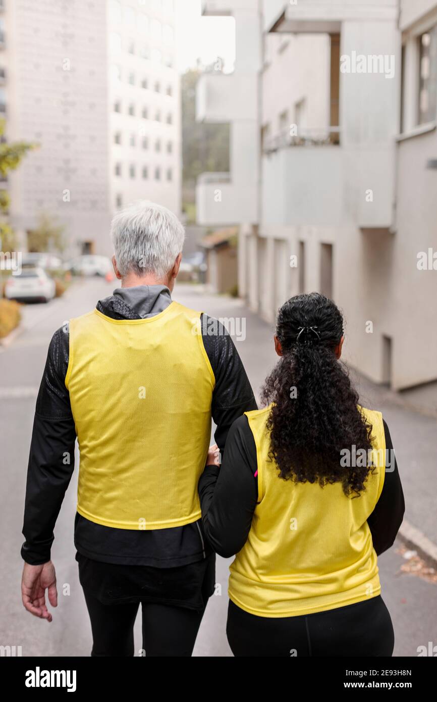 Visually impaired woman walking with guide runner Stock Photo