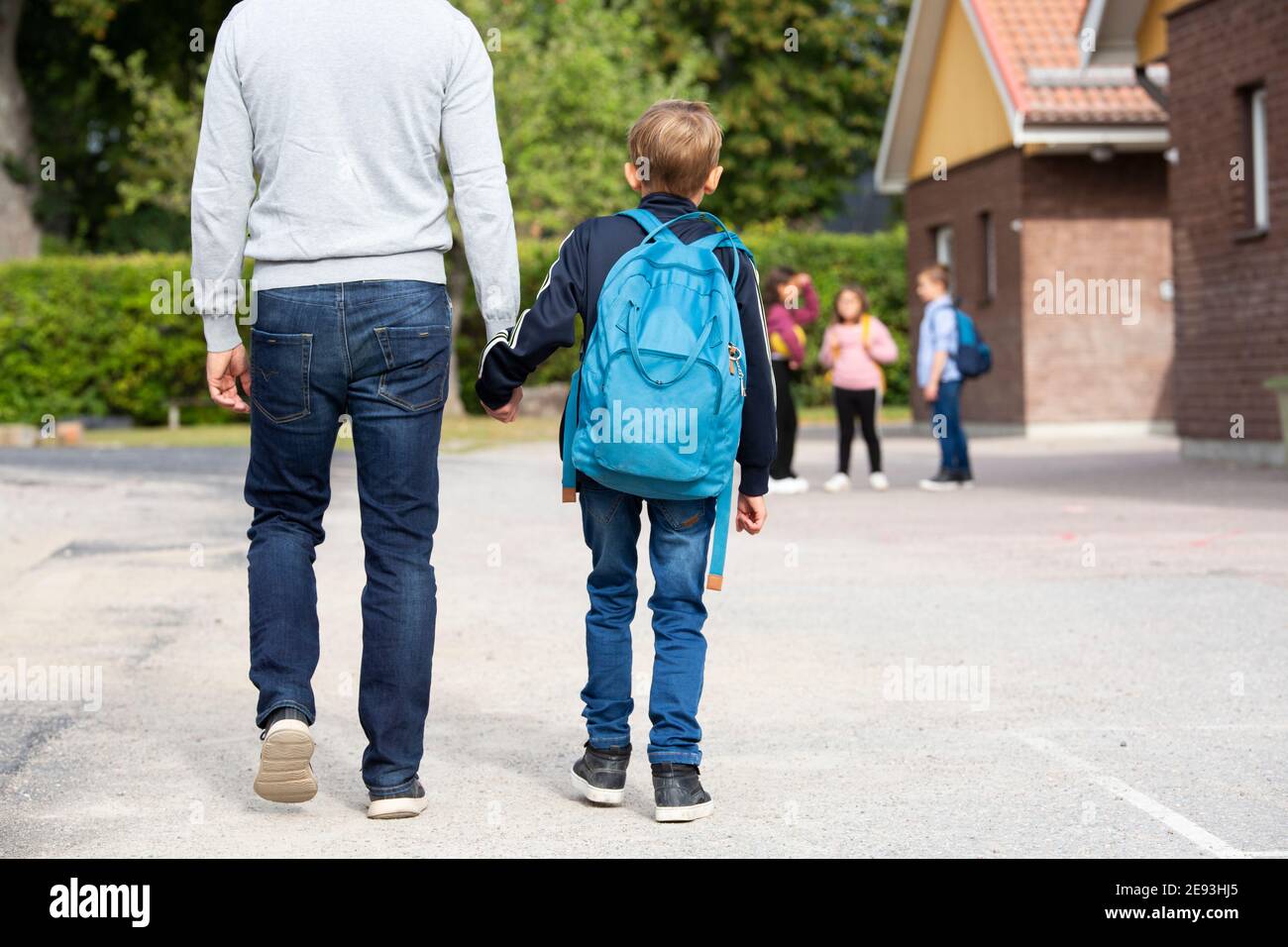 Father taking boy to school Stock Photo Alamy