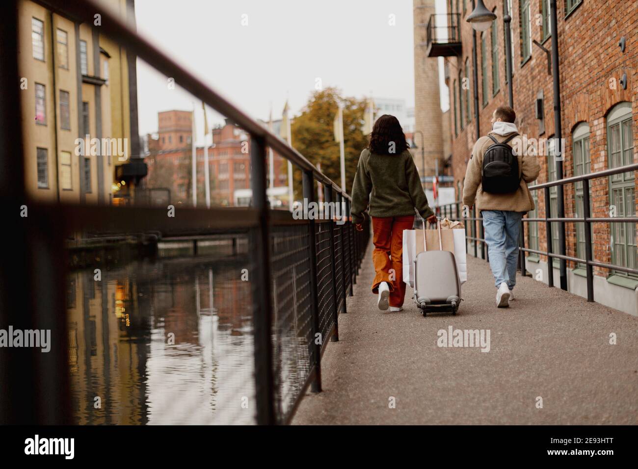 Couple walking along canal in town Stock Photo