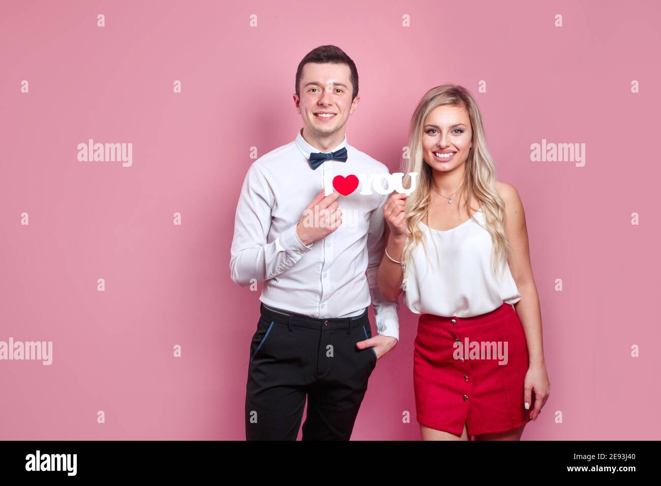 I love you. Happy couple in love on pink background. Happy Valentines day. Stock Photo