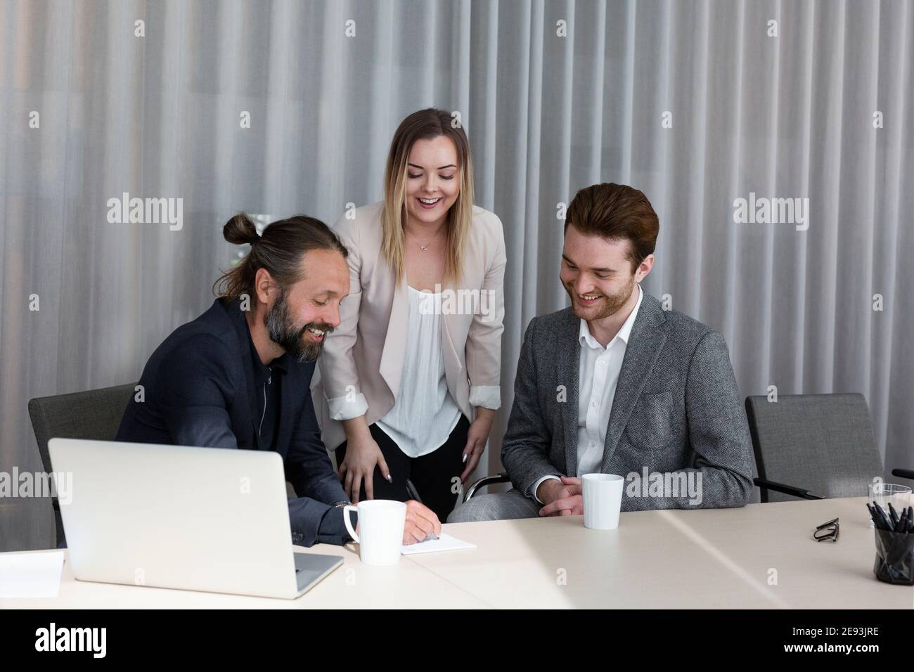 Coworkers talking in boardroom Stock Photo