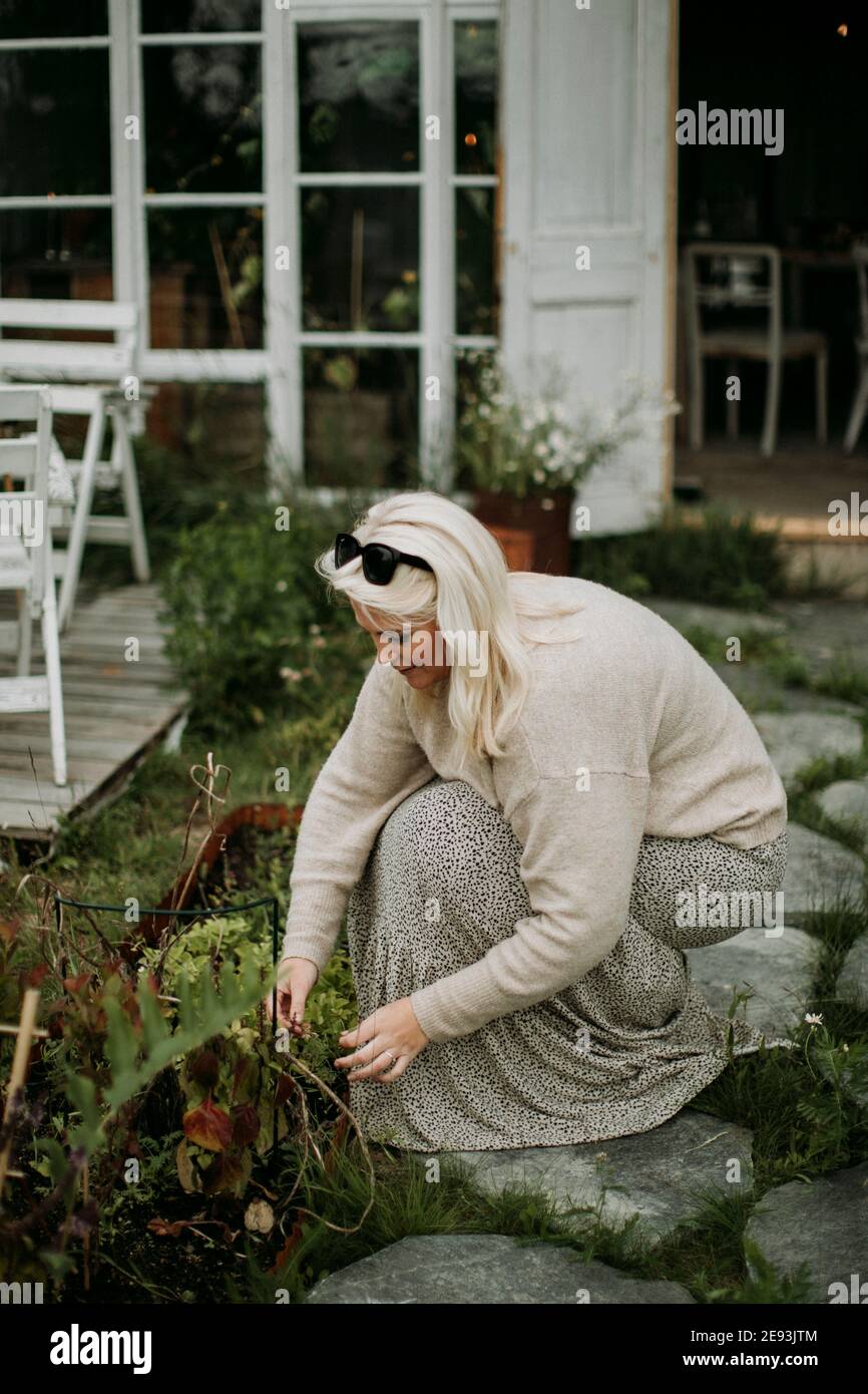 Woman taking care of plants in garden Stock Photo
