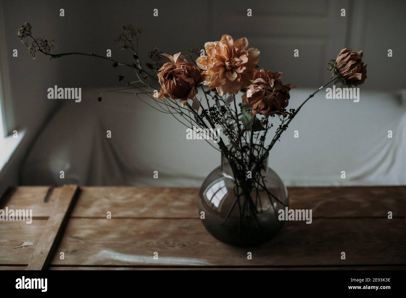 Dried flowers in vase at table Stock Photo