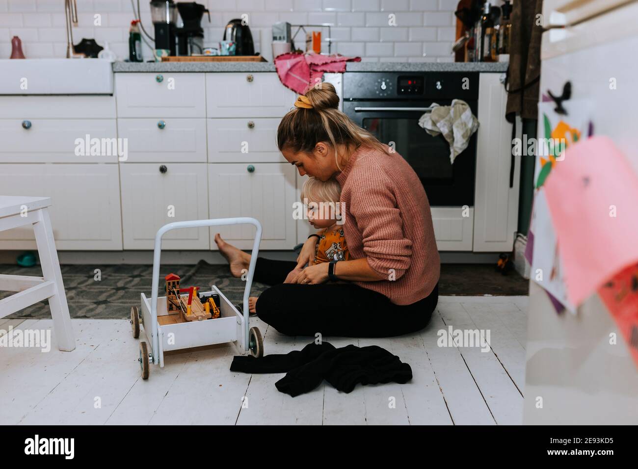 Mother helping toddler to get dressed Stock Photo Alamy