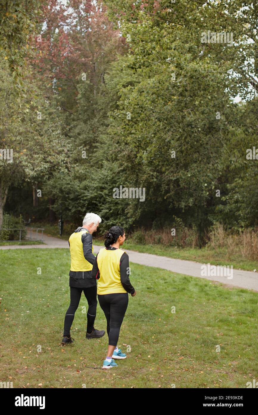 Visually impaired woman jogging with guide runner Stock Photo Alamy