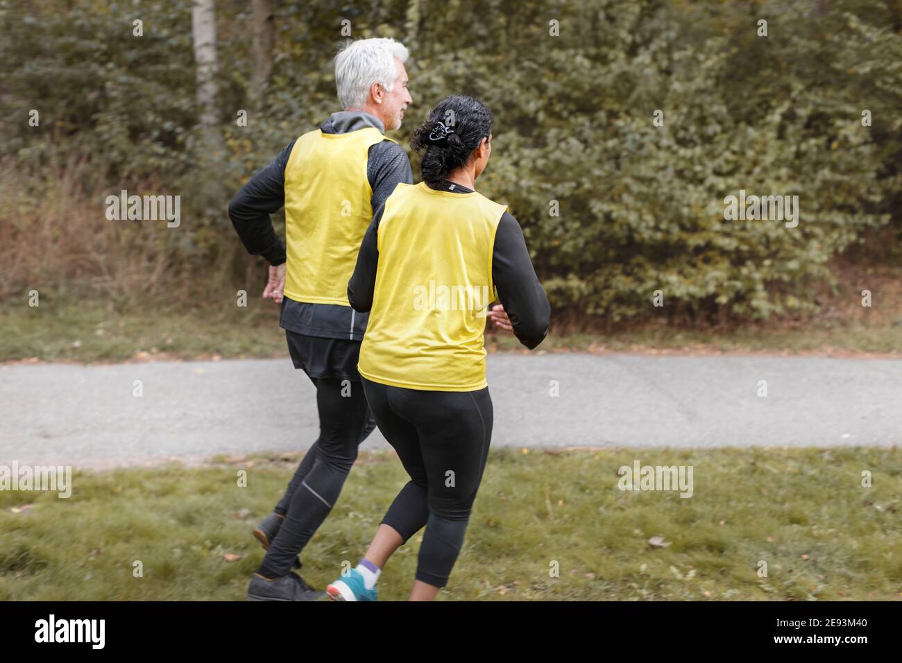 Visually impaired woman jogging with guide runner Stock Photo Alamy