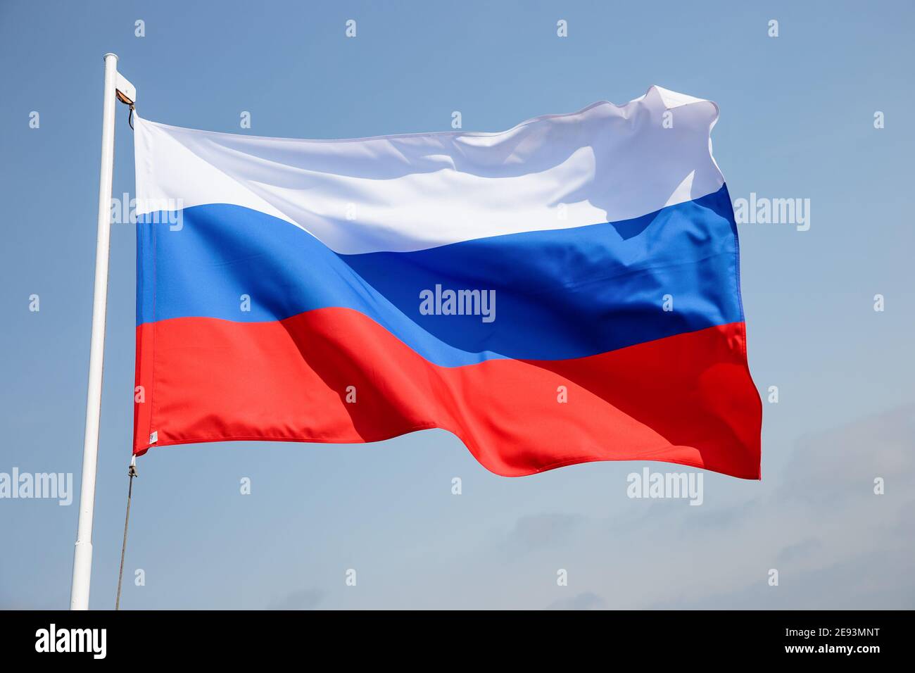 Russia flag is waving in front of blue sky. Stock Photo