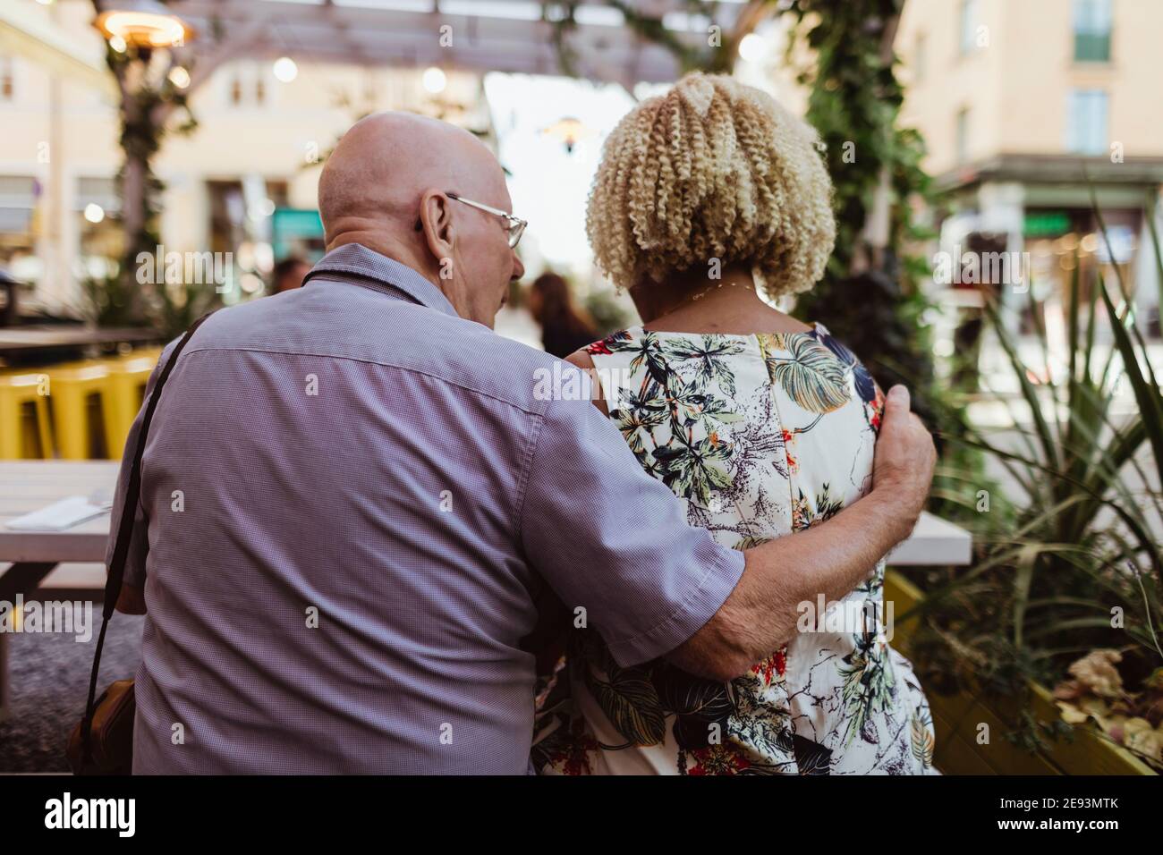 Rear view of senior couple sitting in cafe during vacation Stock Photo