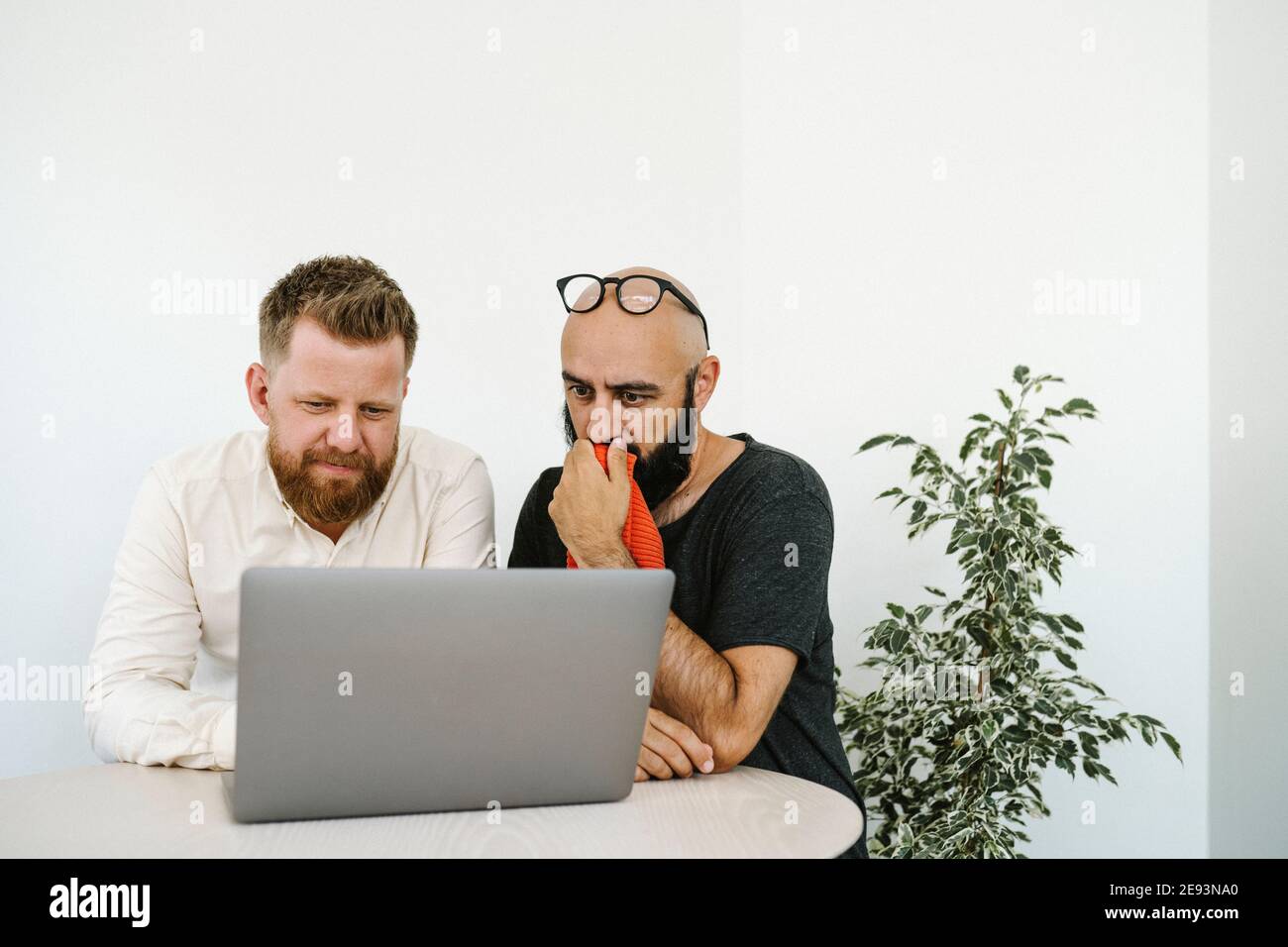 Men using laptop in office Stock Photo