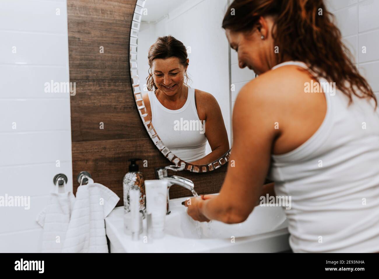 Woman washing hands in bathroom Stock Photo