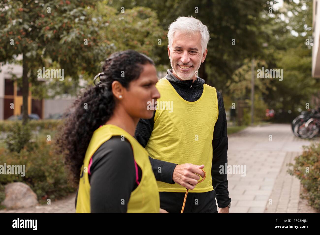 Visually impaired woman preparing for jogging with guide runner Stock Photo