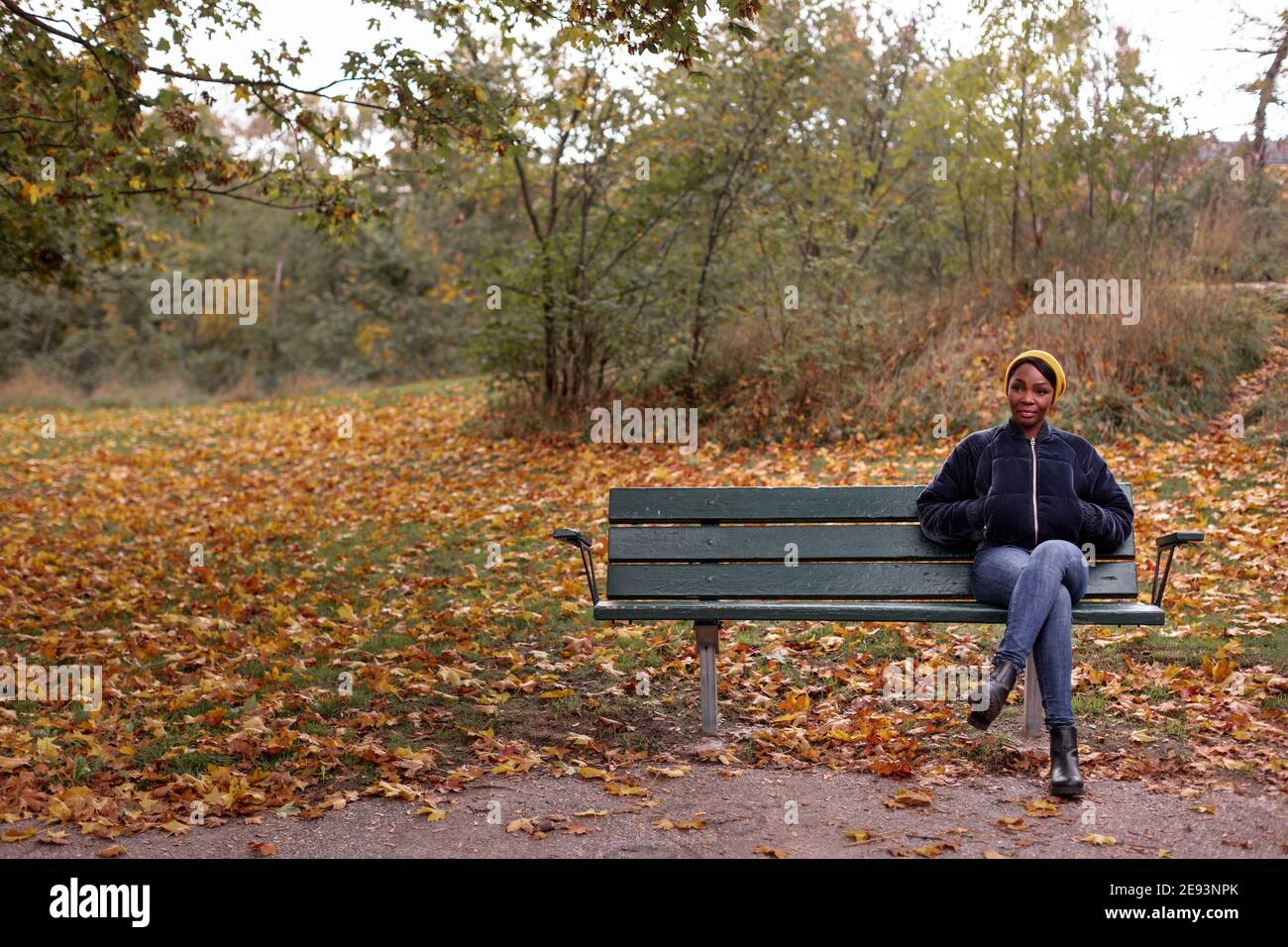 African woman sitting on bench hi-res stock photography and images - Alamy