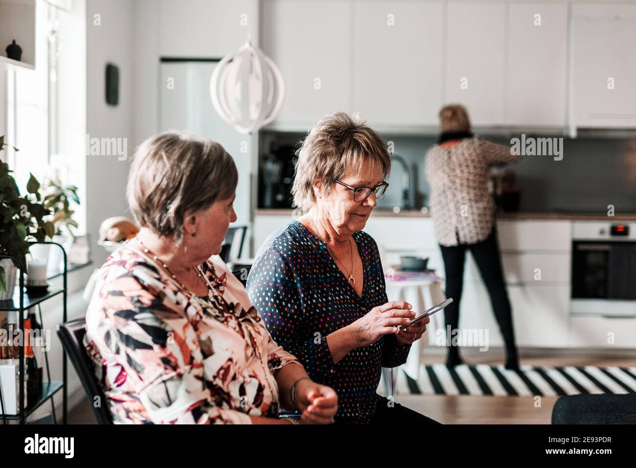 Two smiling old women talking hi-res stock photography and images - Alamy