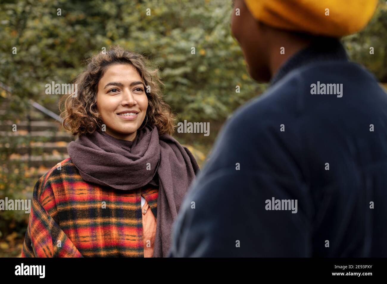 Two young women talking in park Stock Photo