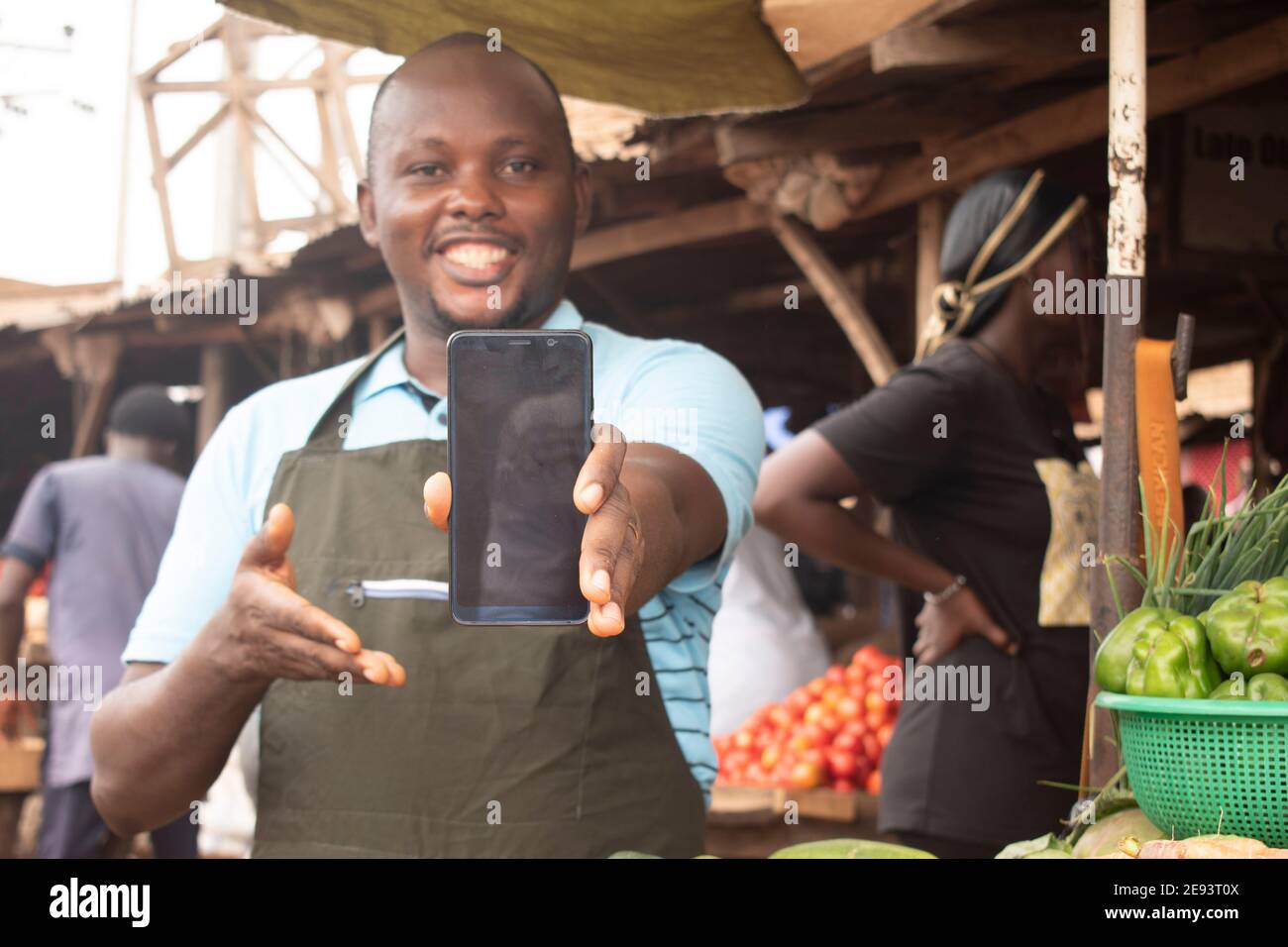 an african man pointing out his phone Stock Photo