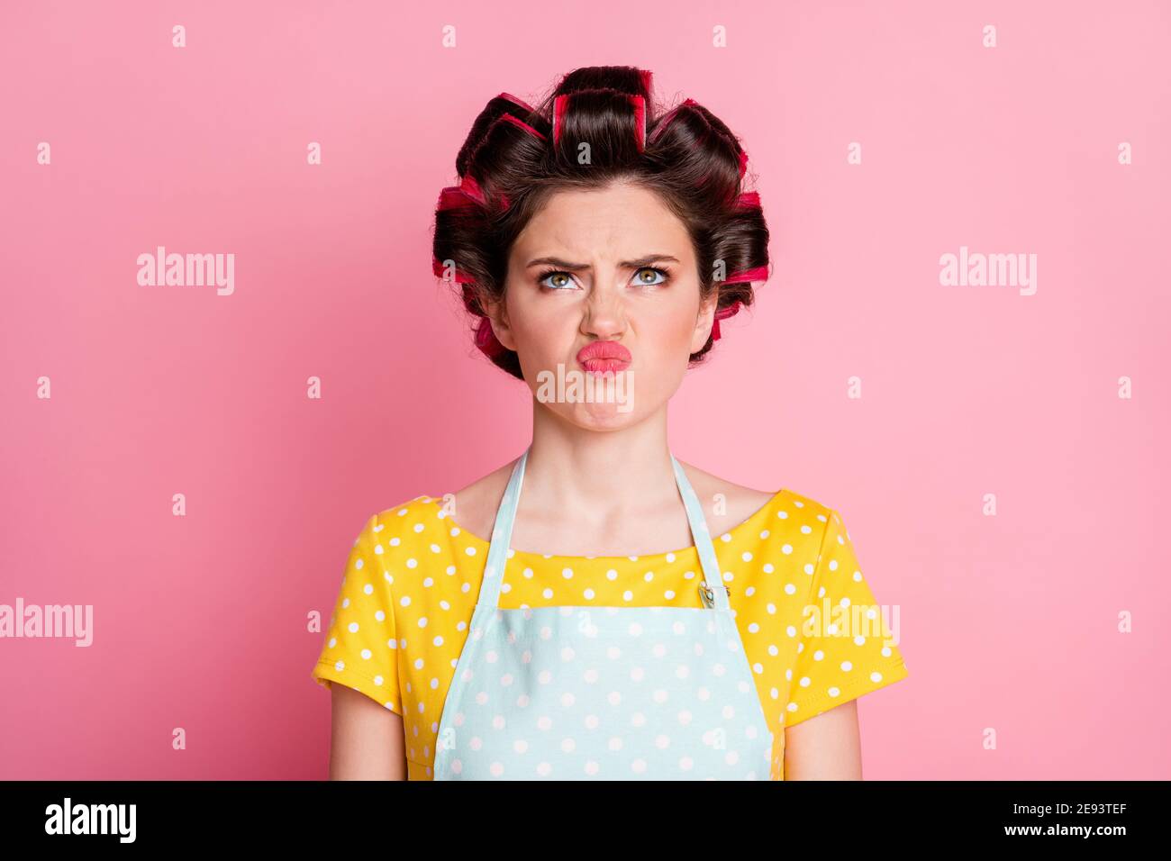 Close-up portrait of her she nice brown-haired housewife wearing curlers bad mood grimacing dislike pout lips isolated on pink pastel color background Stock Photo