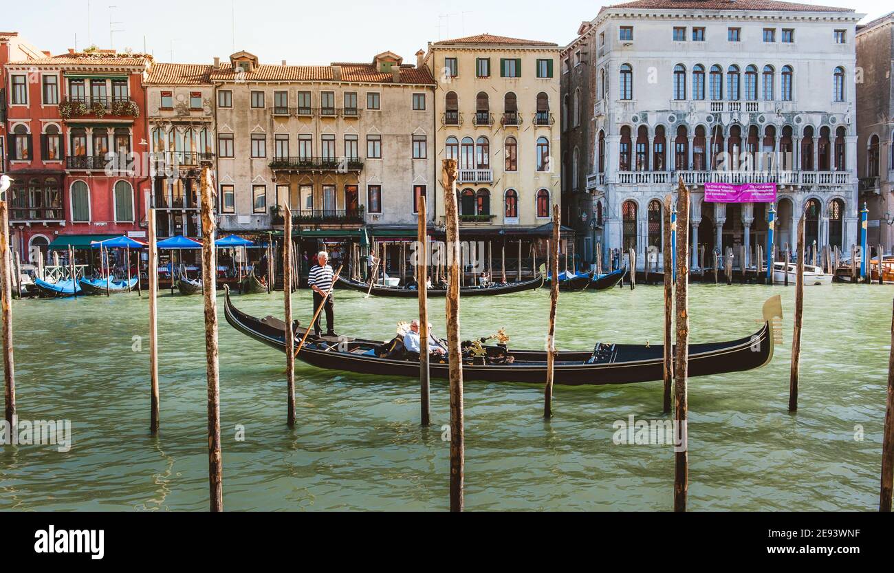 Tourists enjoying a gondola ride on the Grand Canal in the beautiful ...