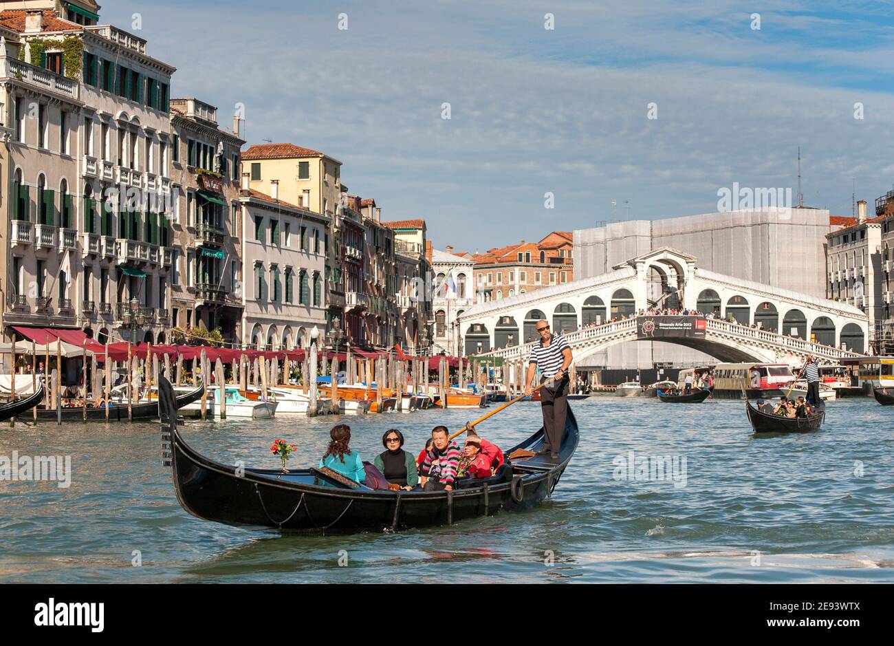 Tourists enjoying a gondola ride on the Grand Canal in the beautiful ...