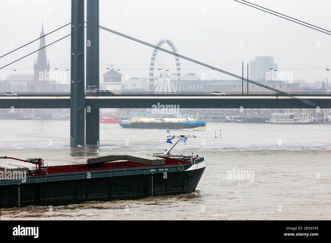 Flood on the Rhine in Dusseldorf - view of the bridge Rheinkniebrucke, old town with Lambertus Church, castle tower and ferris wheel Stock Photo