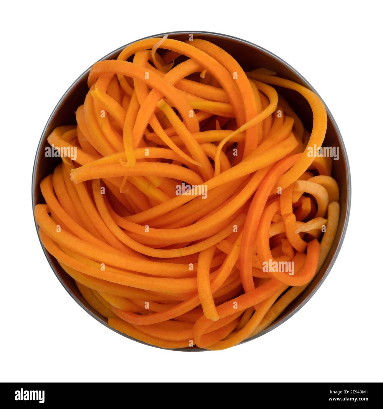 Top view of a metal bowl containing a portion of butternut squash noodles isolated on a white background. Stock Photo