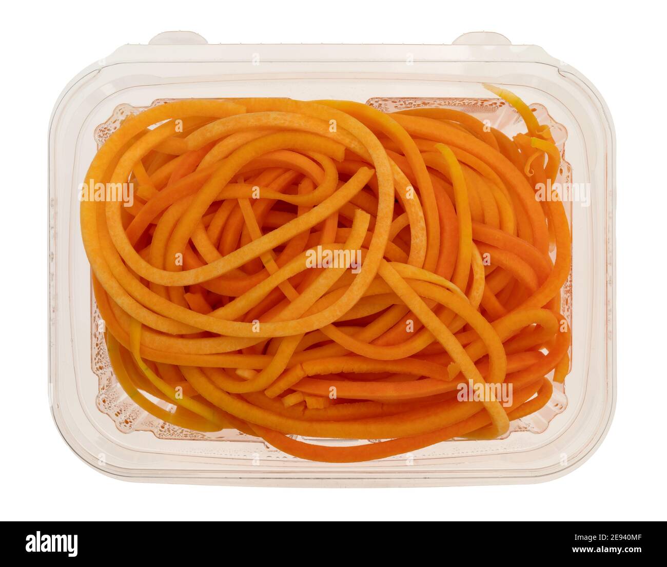 Top view of a plastic container of butternut squash noodles isolated on a white background. Stock Photo