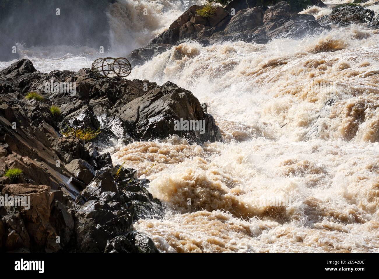 Mekong river, Laos. Fish trap on the rocks surrounded by the muddy
