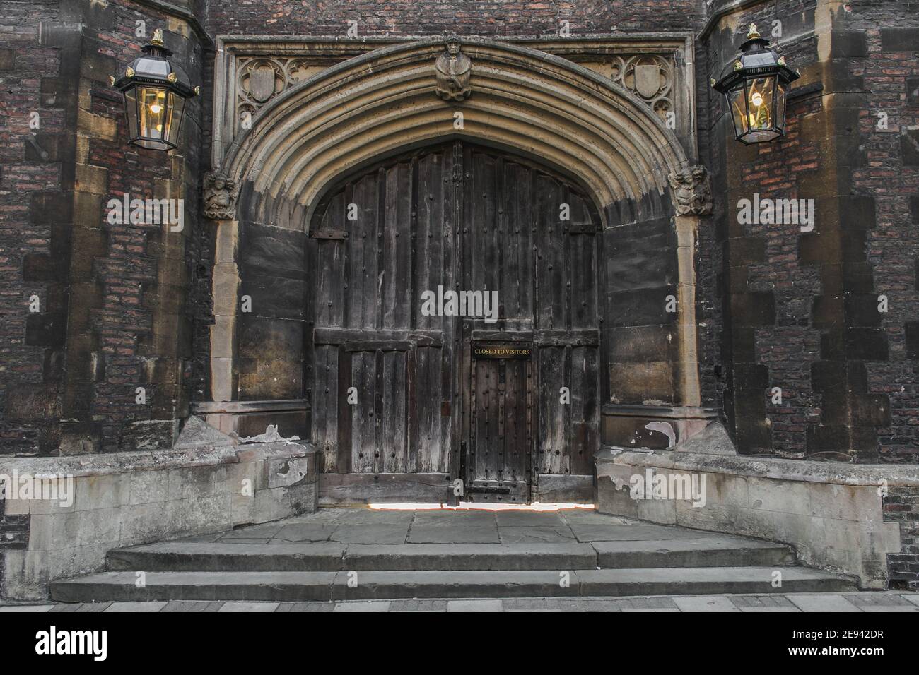 Wooden door of Queen's College situated at Queen's Lane in Cambridge, England, UK. Stock Photo