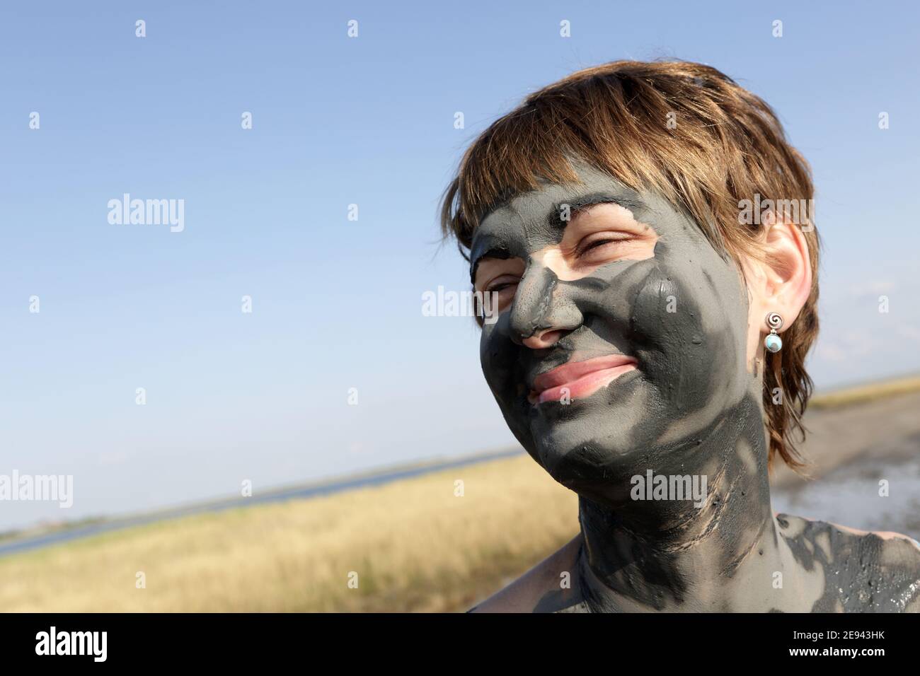Woman applying mineral mud hi-res stock photography and images - Alamy