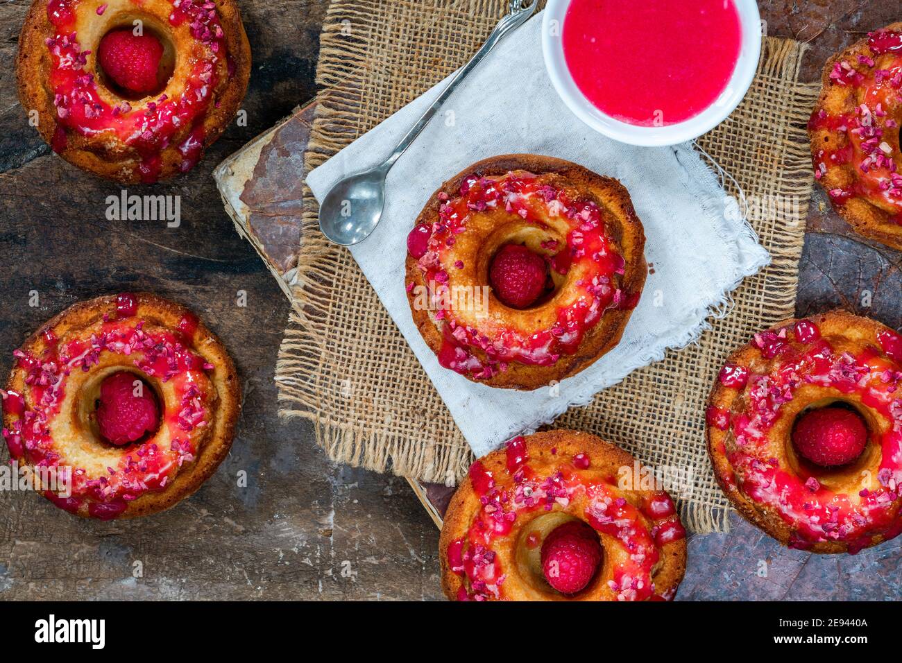 Mini vanilla pound cakes with raspberry icing - overhead view Stock Photo