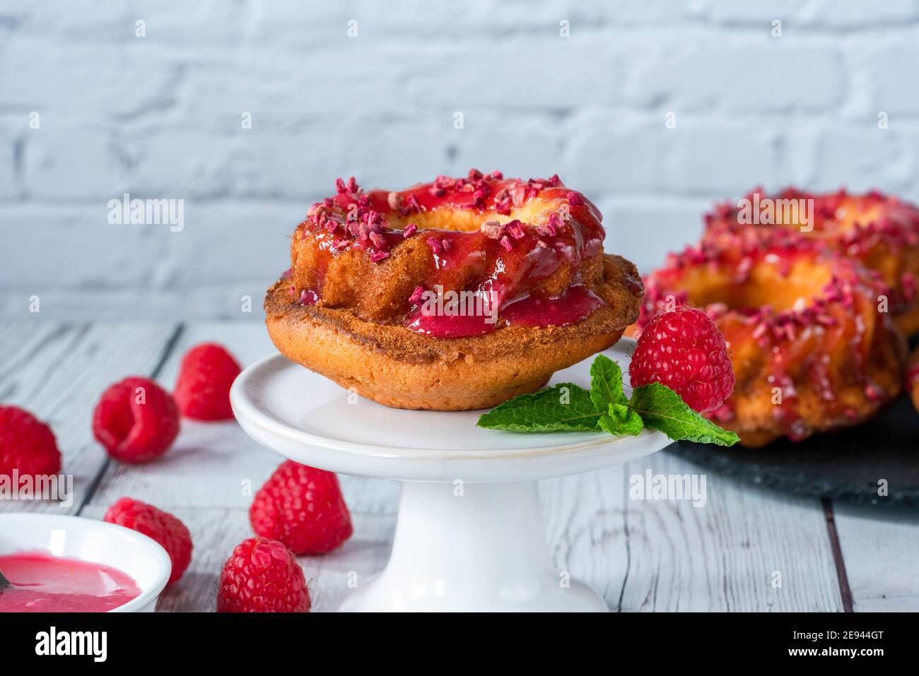 Mini vanilla pound cakes with raspberry icing Stock Photo