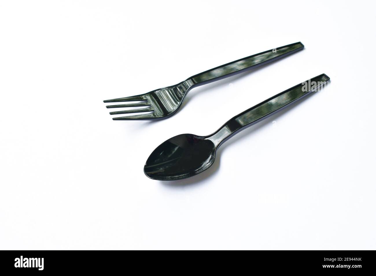 black plastic spoon and fork for single used on white background Stock Photo
