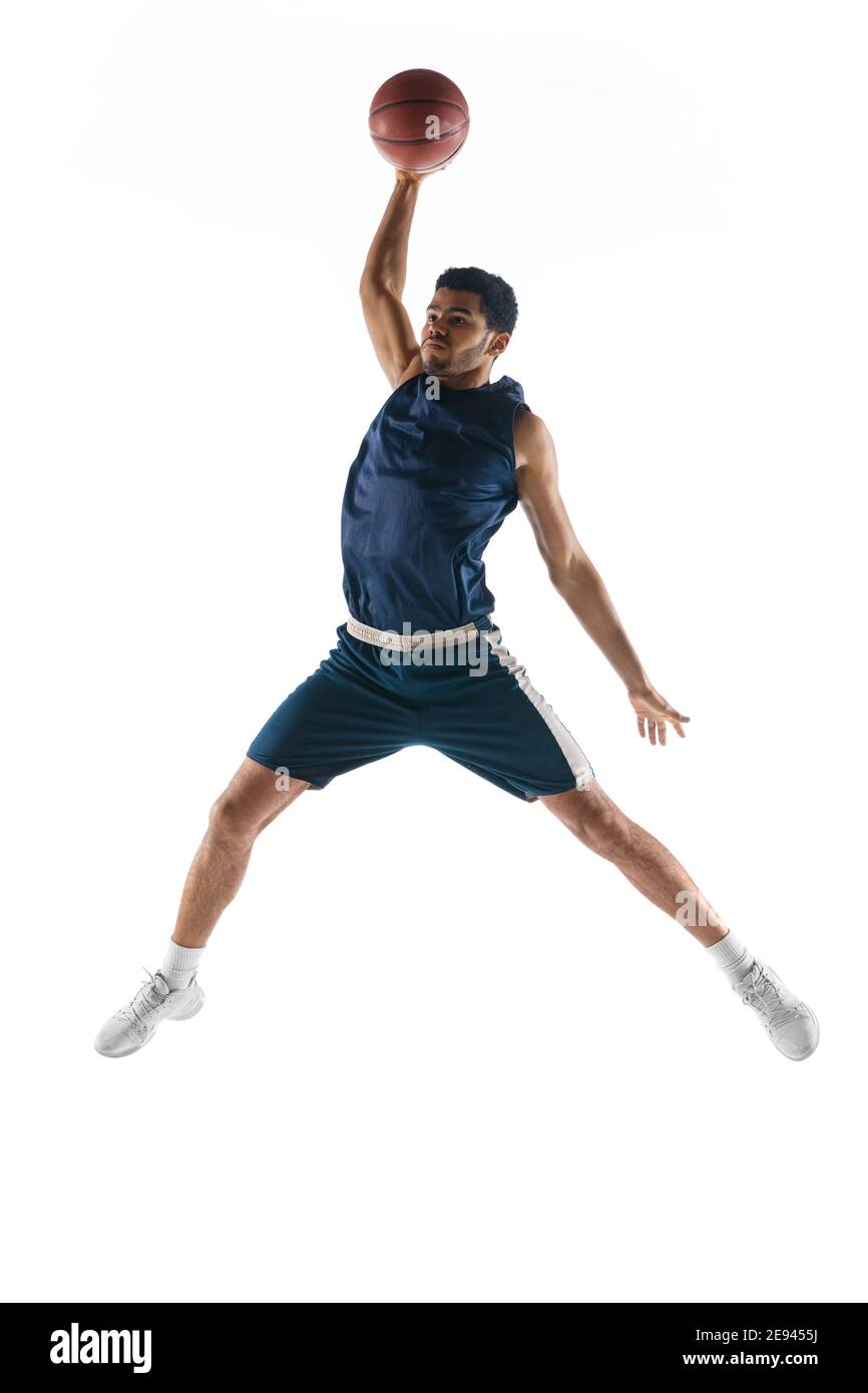 Slam dunk. Young arabian muscular basketball player in action, motion  isolated on white background. Concept of sport, movement, energy and  dynamic, healthy lifestyle. Training, practicing Stock Photo - Alamy