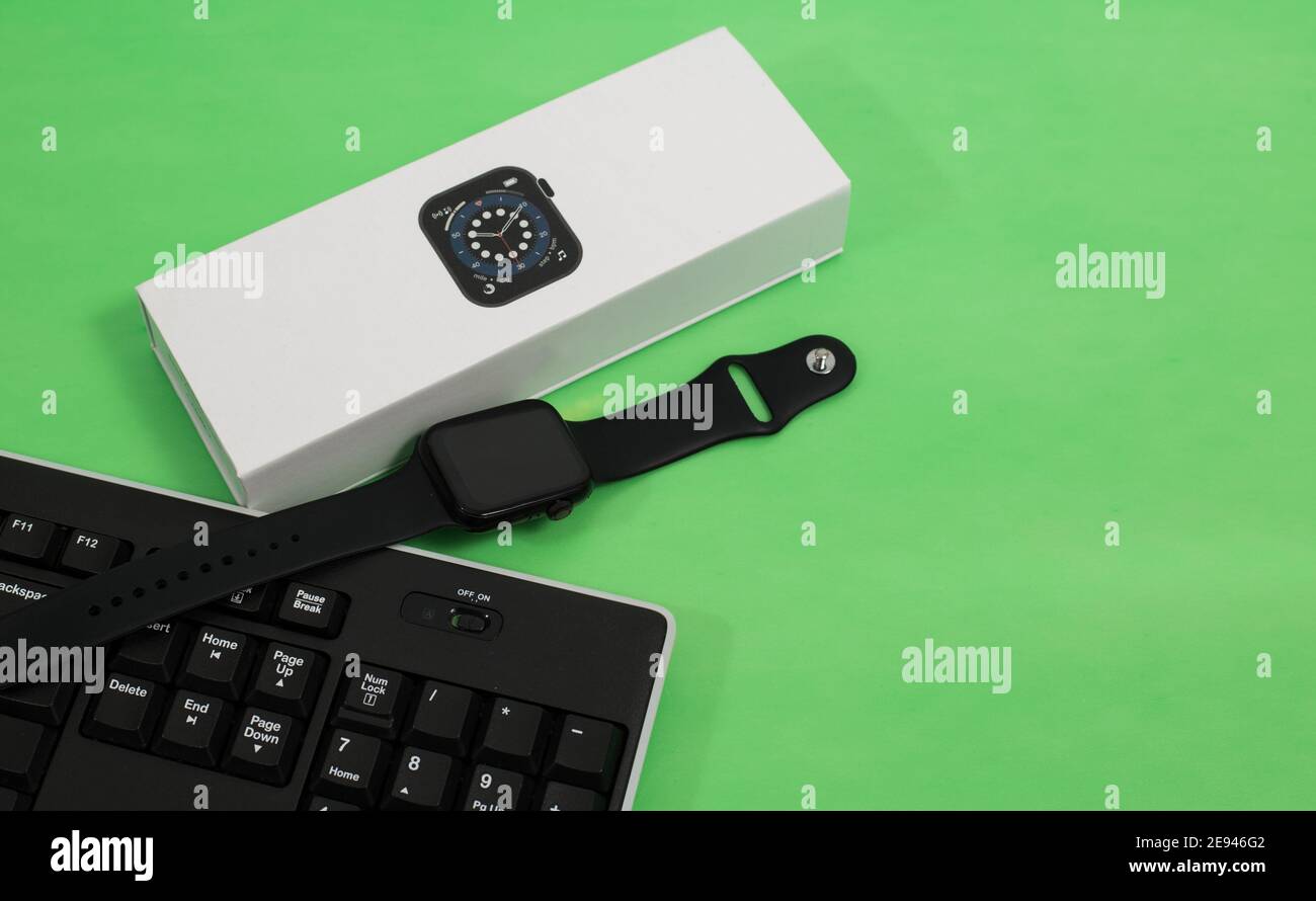 Smartwatch and keyboard on green background Stock Photo Alamy
