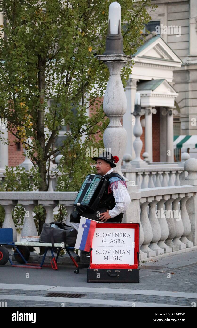 Slovenian musician with his Beltuna accordion on the Triple Bridge in Ljubljana Stock Photo