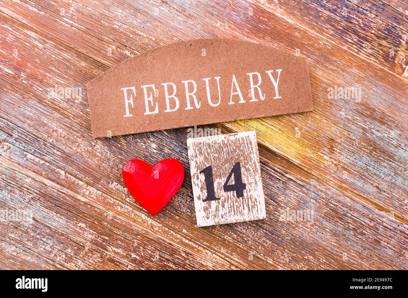 Red heart with a calendar on February 14 on wooden cbackground. Concept of love, wedding, romance and happy Valentine's Day. Stock Photo